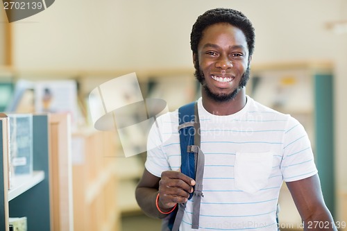 Image of Student Carrying Backpack In Library