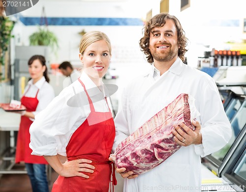 Image of Confident Butchers With Meat Package