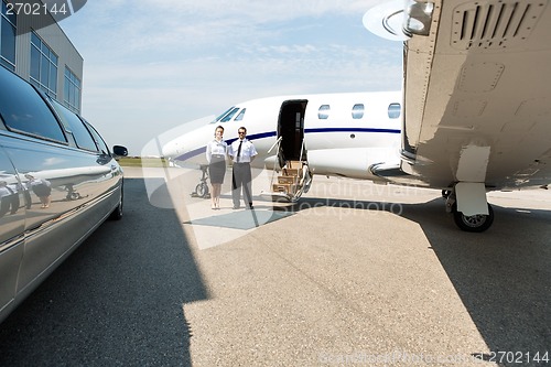 Image of Stewardess And Pilot Standing Neat Limousine And Private Jet