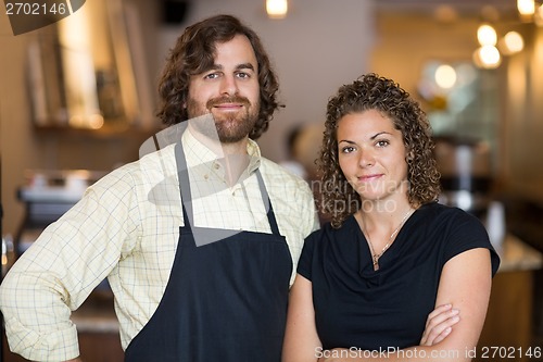 Image of Confident Owners Standing Together In Cafe