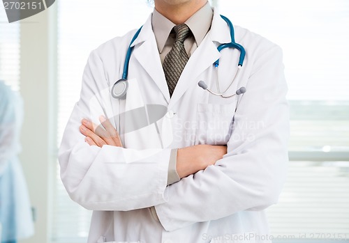 Image of Cancer Specialist Standing Arms Crossed In Hospital Room