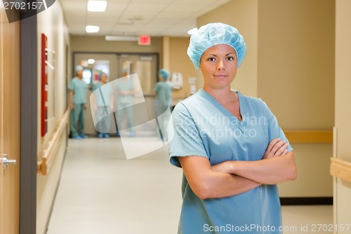 Image of Doctor Standing Arms Crossed In At Hospital Corridor