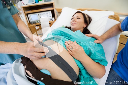 Image of Nurse Preparing Pregnant Woman For Heartbeat Examination