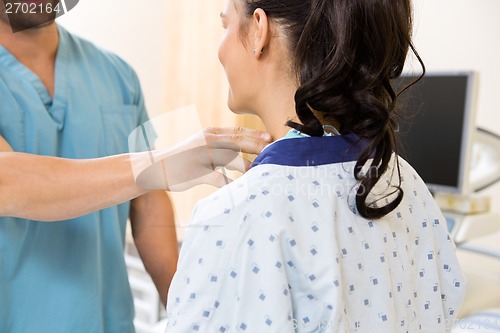 Image of Nurse Examining Patient's Neck Before Ultrasound Test