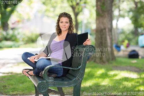 Image of Confident Student Sitting On Bench At Campus