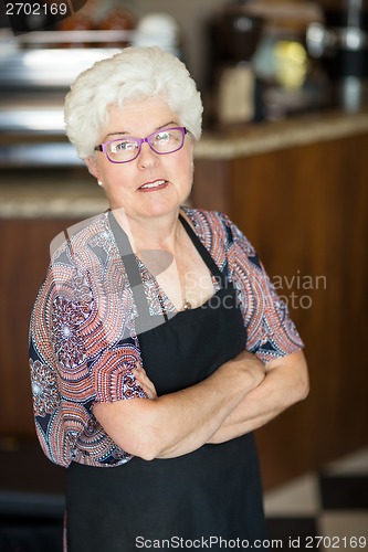 Image of Owner With Arms Crossed Standing In Cafeteria