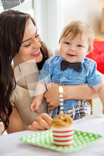 Image of Baby Boy And Mother With Birthday Cake On Table