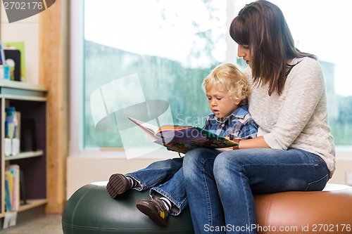 Image of Teacher With Schoolboy Reading Book