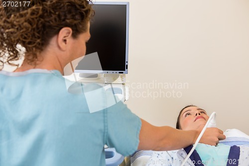 Image of Nurse Scanning Female Patient's Neck
