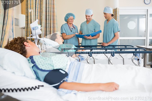 Image of Nurses Examining Patient's Test Report