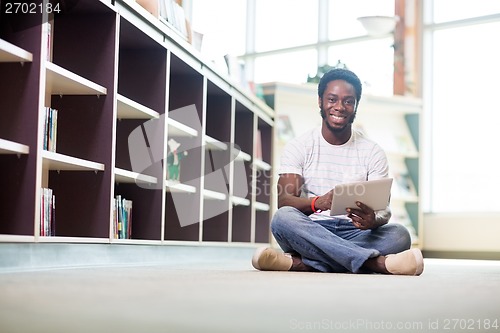 Image of Student Using Digital Tablet In Library