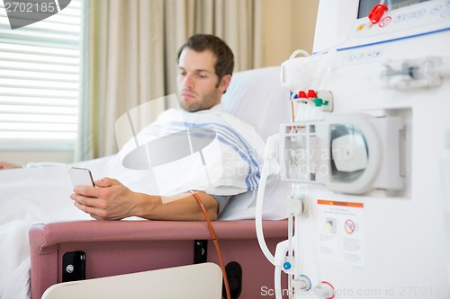 Image of Patient Using Mobilephone at Dialysis Center