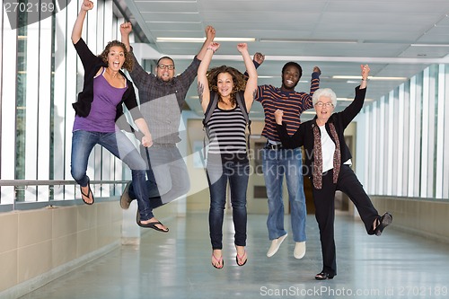 Image of Excited Multiethnic University Students Jumping