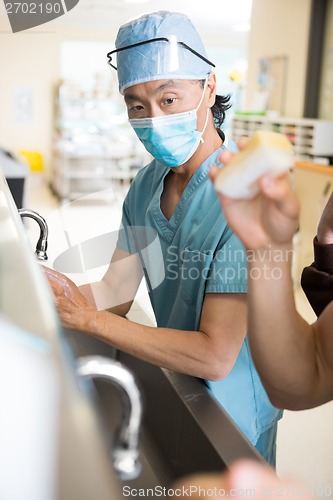 Image of Surgeon Scrubing Arms and Hands