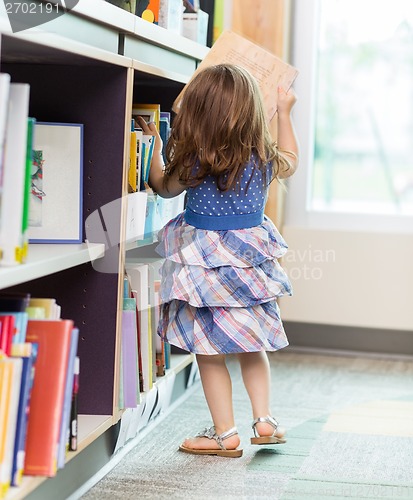 Image of Girl Selecting Book In Library