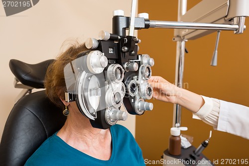 Image of Woman Undergoing Eye Examination With Phoropter