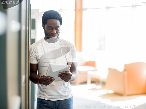 Image of Student Using Digital Tablet At Library