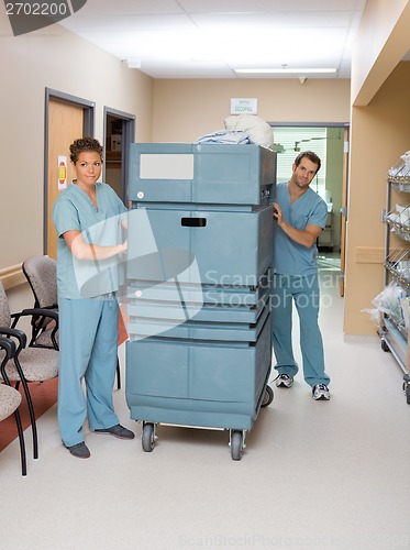 Image of Nurses Pushing Trolley In Hospital Hallway