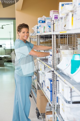 Image of Female Nurse Working In Storage Room