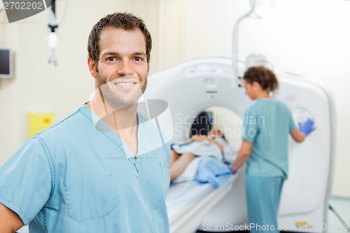 Image of Nurse With Colleague Preparing Patient For CT Scan