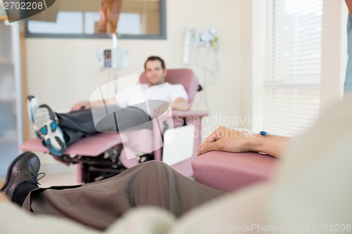 Image of Man With IV Drip Attached To His Hand