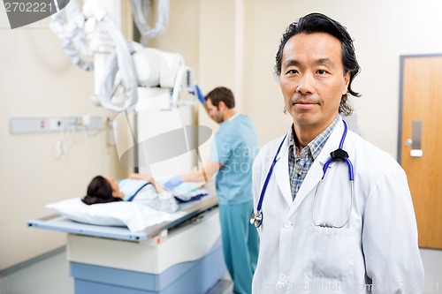 Image of Radiologist With Nurse Preparing Patient For Xray