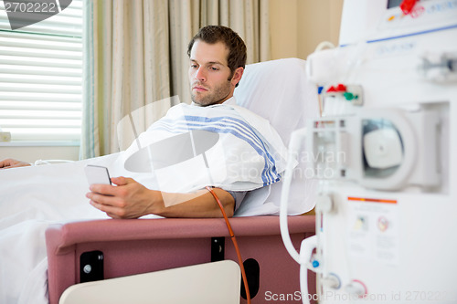 Image of Patient Using Mobilephone at Dialysis Center