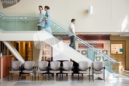 Image of Medical Team And Man Using Staircase In Hospital