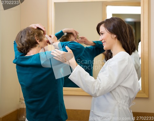 Image of Ophthalmologist Assisting Woman To Insert Contact Lens