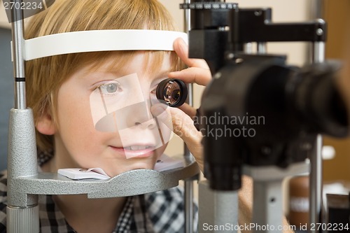 Image of Optician's Hand Checking Boy's Eye With Lens