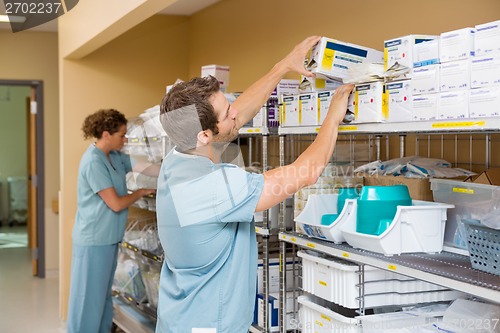 Image of Nurses Arranging Stock In Storage Room