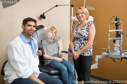 Image of Optician With Customers Smiling In Store