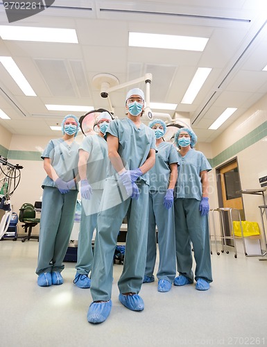 Image of Medical Team In Scrubs Standing Inside Operation Room