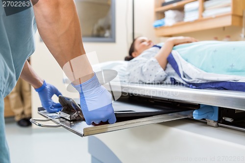 Image of Nurse Preparing For Xray In Examination Room