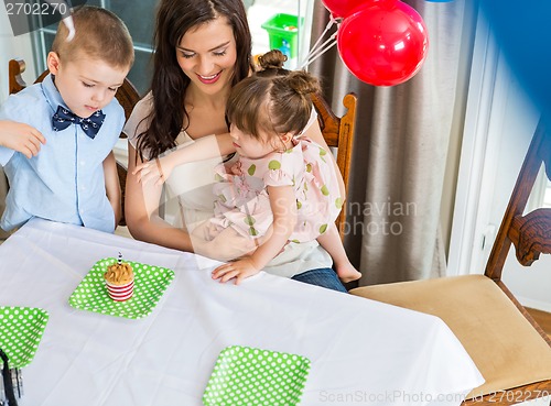 Image of Mother And Children Celebrating Birthday Party