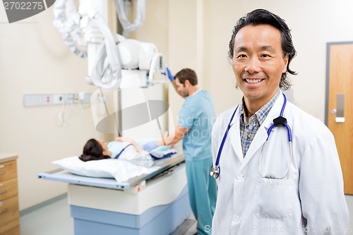 Image of Doctor With Nurse Preparing Patient For Xray