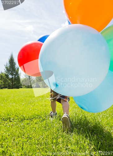 Image of Boy With Colorful Balloons In Park
