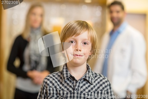 Image of Confident Boy With Optometrist And Mother At Store