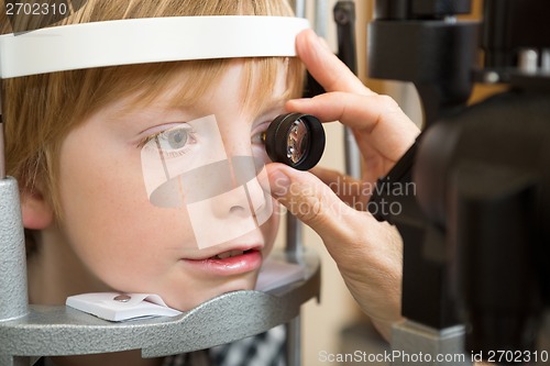 Image of Optician's Hand Examining Boy's Retina