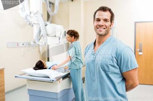 Image of Nurse With Colleague Preparing Patient For Xray