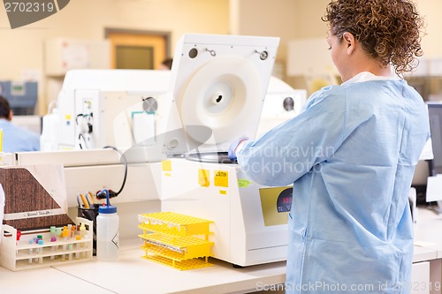 Image of Scientist Using PCR Machine In Laboratory
