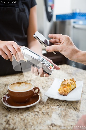 Image of Customer Paying using NFC