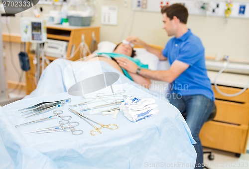 Image of Operating Equipment On Table With Couple In Background At Hospit