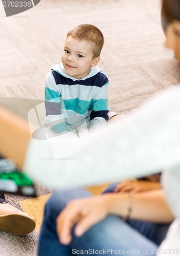 Image of Boy Listening To Teacher In Library