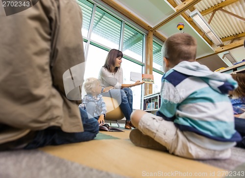 Image of Teacher Reading To Students In Library