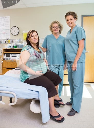 Image of Female Nurses With Pregnant Woman In Hospital Room