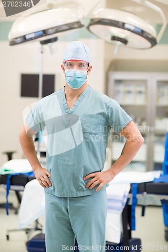 Image of Male Doctor With Hands On Hips In Operation Room