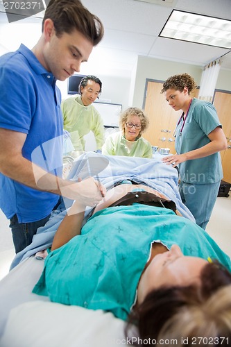 Image of Man Holding Woman's Hand During Delivery In Hospital