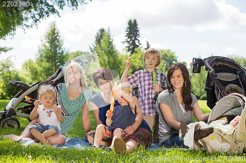 Image of Happy Mothers And Children Enjoying Picnic
