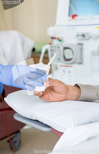 Image of Nurse Giving Crushed Ice To Patient On Renal Dialysis